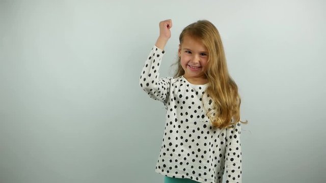 Beautiful blonde little girl smiling and gesturing. Slow motion of yes gesture by cute child. 