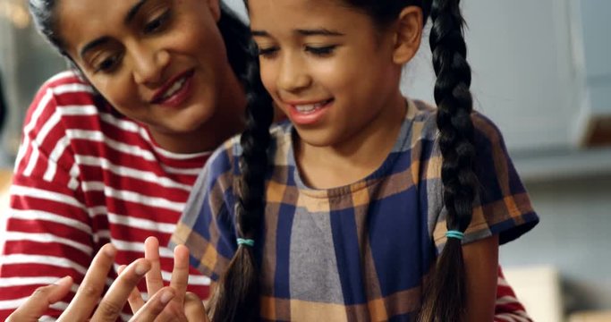Mother and daughter counting fingers 