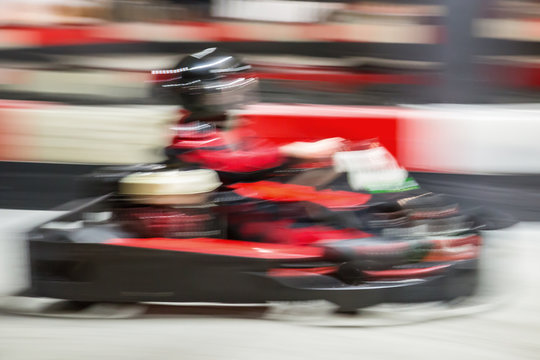 Cart blurred by high speed, a boy having fun - driving fast, racing, speeding. 