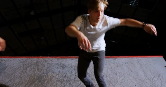 Male friends practicing skateboarding 