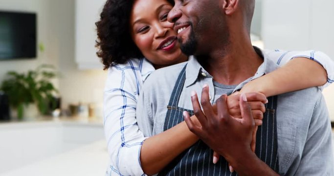 Couple embracing each other at home 