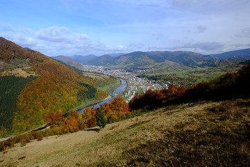 Mountain autumn landscape, view from ski elevator to small town or village