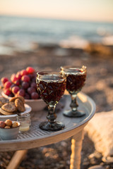 romantic dinner with wine and grapes by seaside