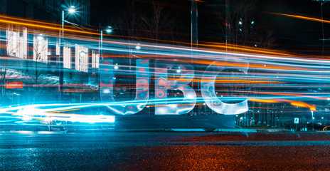 Long exposure of vehicles whizzing by UBC sign
