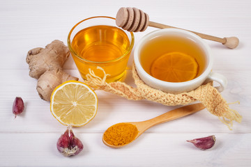Cup of hot tea with lemon and ingredients for preparation warming beverage