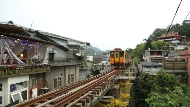 People travelers in a taiwan train Station see as the yellow train lets go, the train its a Diesel Multiple Unit DR3100-Ziqiang Express, High Class Passenger Train-Dan