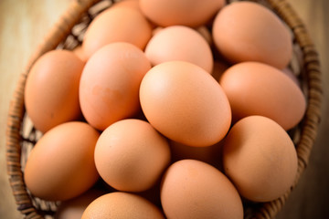 Eggs in basket on wood board