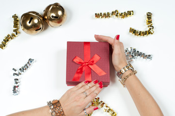 Woman wearing bracelet, Christmas gift on a wooden table background