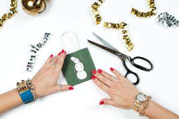 Woman wearing bracelet, Christmas gift on a wooden table background