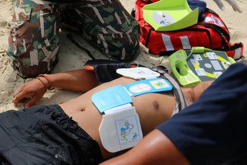 CPR and AED on the beach, Training for Rescue and first aid - obrazy, fototapety, plakaty
