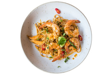 Spicy spaghetti with shrimps isolated on white background