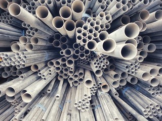Close up Steel pipes of various sizes placed stacked.
