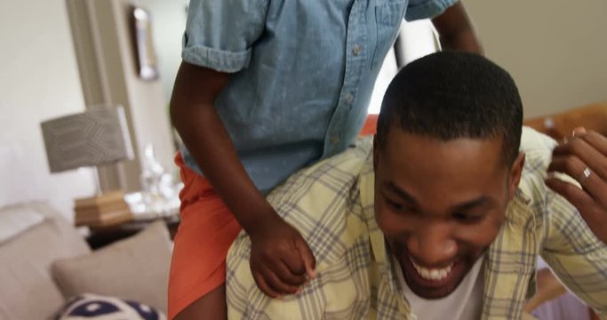 Father giving a piggyback ride to his son 