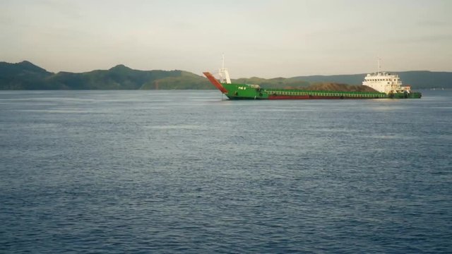 Traveling shot from boat of container cargo cruising in Dapa channel