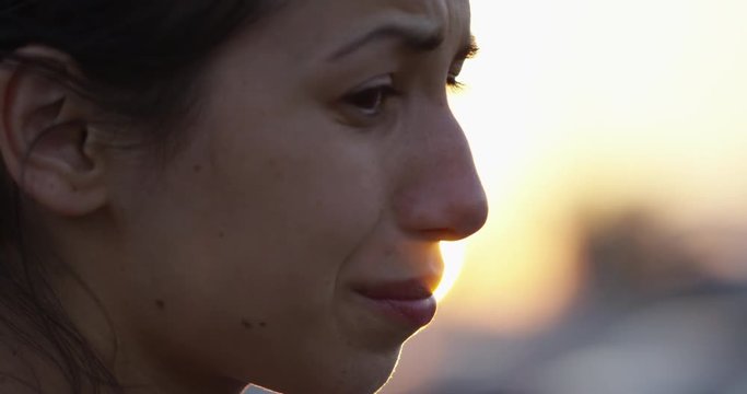 Sad woman at sunset - close up on face