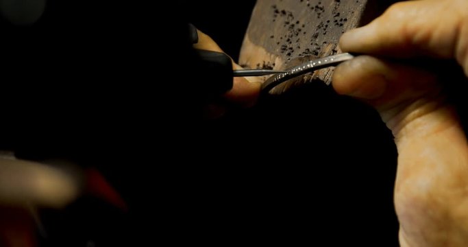 Goldsmith manufacturing bangle in workshop 