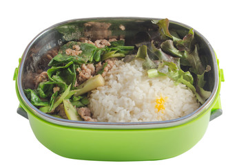 new steamed rice and fried pork chinese kale.they are in green plastic tiffin isolated on white background with clipping path