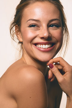 a girl smiling with nude make up