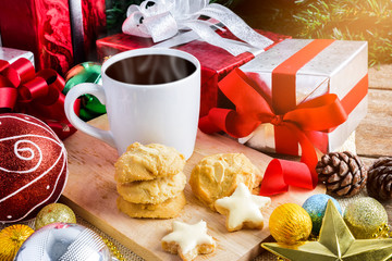 A cup of tea or coffee with Festive Decoration, Christmas Cookie and New Year  on table