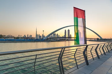 Peel and stick wall murals Burj Khalifa Dubai Downtown skyline with UAE national flag at sunrise. Dubai, UAE.