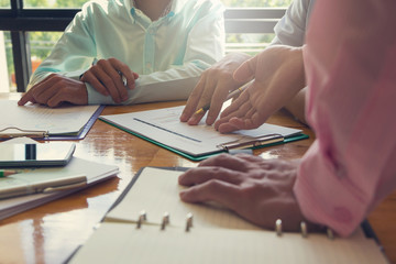 Business and finance concept of office working,Teamwork of Businessmen using calculator to discussing analysis Chart