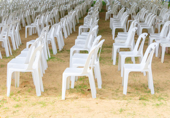 Row of white chairs plastic on lawn prepare business meeting