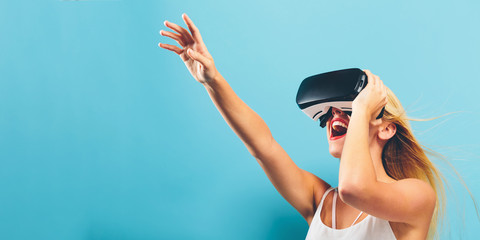 Happy young woman using a virtual reality headset