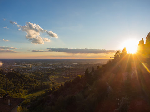 Fiery sunset from Bergamo city to the Po valley. Lombardy, Italy. Sunset during fall season