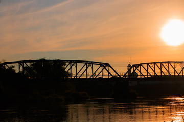 silhouette railway bridge and reflex in river before sunrise in the morning with copy space add text