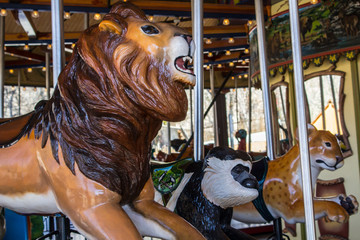 lion on a merry-go-round with a monkey and tiger