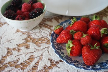 Fresh berries on a white lace tablecloth