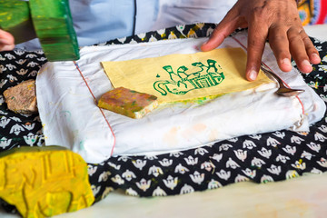 Hand holds stamp for dyeing cloth