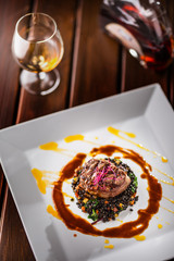 Beef Steak. Grill beef steak black lentils mixed with vegetable. Cognac or brandy as drink. Culinary food in hotel pub or restaurant