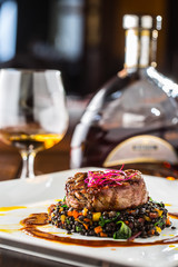Beef Steak. Grill beef steak black lentils mixed with vegetable. Cognac or brandy as drink. Culinary food in hotel pub or restaurant