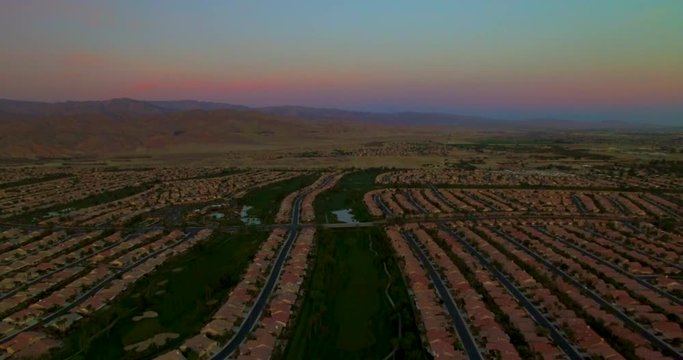 Descending aerial shot over Palm Desert in Palm Springs at dusk