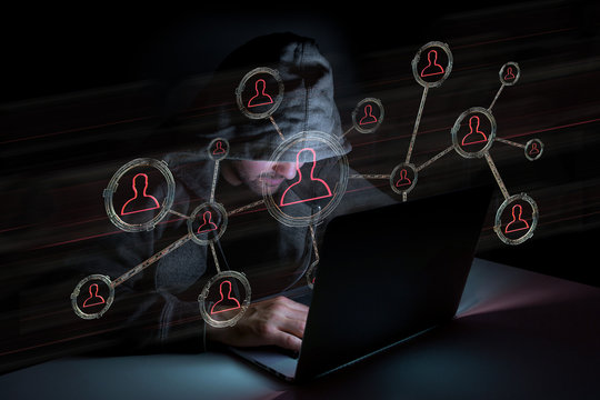 Hacker man in the dark using computer to hack data and information system