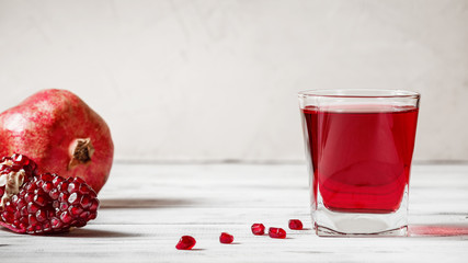 Glass of pomegranate juice with fresh pomegranate fruit