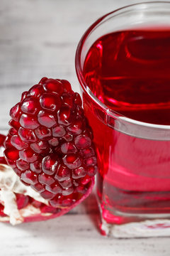 Glass of pomegranate juice with fresh pomegranate fruit