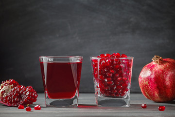 Glass filled with pomegranate seeds on the table