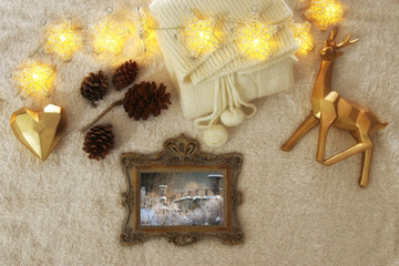 Winter concept with cozy lifestyle objects over fur carpet. Top view.