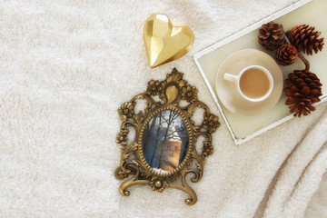 Winter concept with cozy lifestyle objects over fur carpet. Top view.