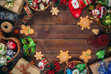 Christmas  background with gingerbread, decorations and gift boxes, balls, toy on vintage old wooden board. Beautiful xmas frame. Idea for advertising, posters, flyers, postcard. Top view. Free space