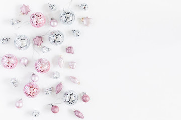 Christmas composition. Christmas balls, pink and silver decorations on white background. Flat lay, top view, copy space