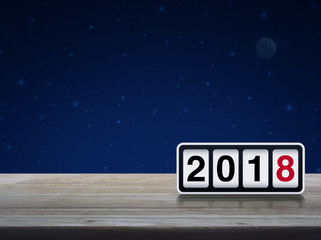 Retro flip clock with 2018 text on wooden table over fantasy night sky and moon, Happy new year concept
