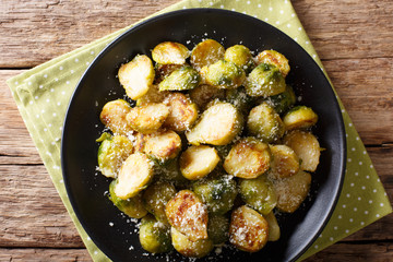 roasted brussels sprouts with garlic and Parmesan cheese on a plate close-up. horizontal top view