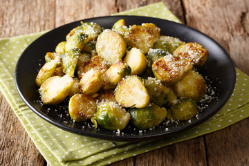 Vegetarian food: fried Brussels sprouts with garlic and Parmesan cheese close-up. horizontal