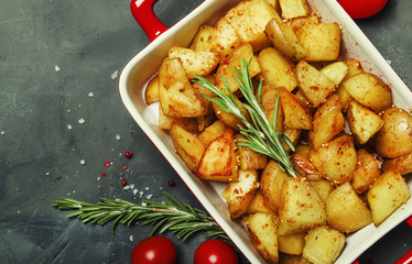 Baked potatoes with spices and rosemary, top view