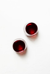 Red wine in glasses on a white background, top view