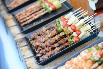 Steak barbecues cooking grilling in street market in thailand,Barbecue grill with various kinds of meat, Soft focus