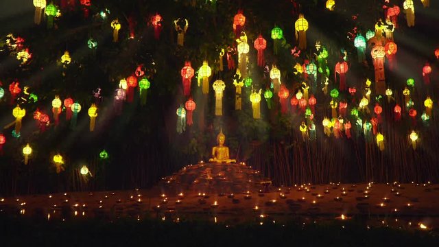 Monk light a candles and lanterns to pray the Buddha in Temple, Chiang Mai, Thailand